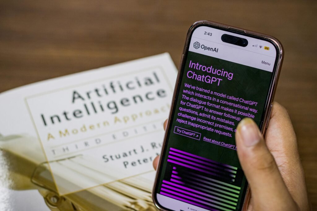 close up of a person holding a smartphone displaying chatgpt