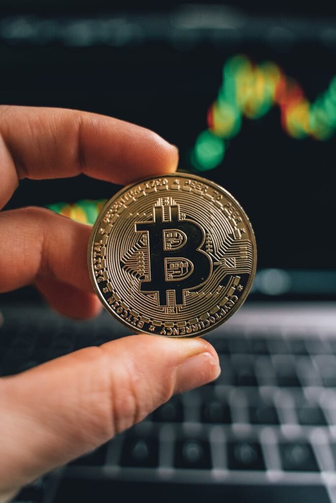 a person holding a gold bitcoin