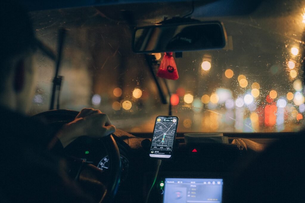 a person driving a car navigating with google map on cellphone