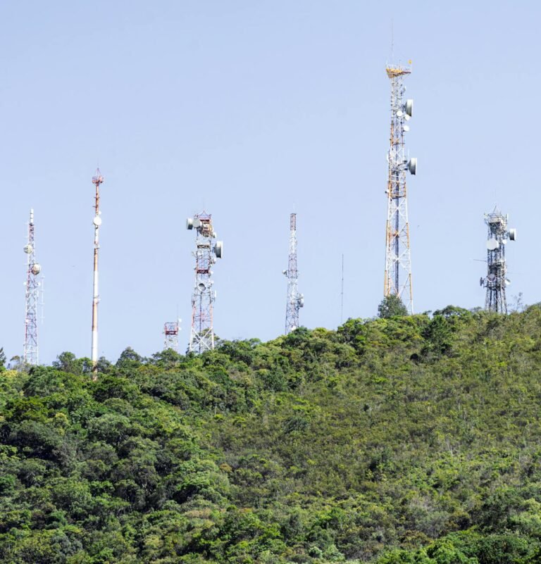 communication towers on green hillside in brazil