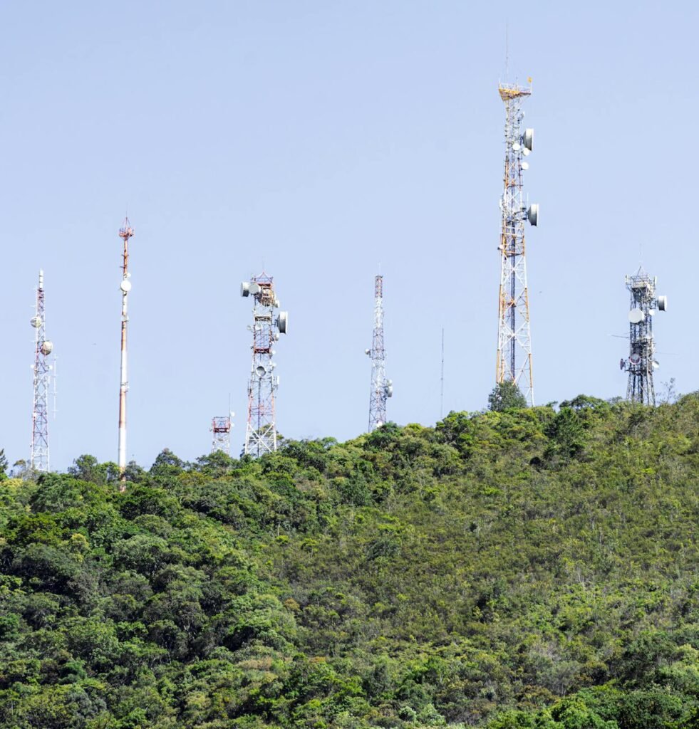 communication towers on green hillside in brazil
