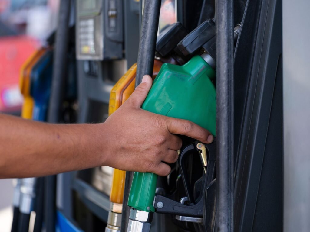 a person s hand holding a gas pump