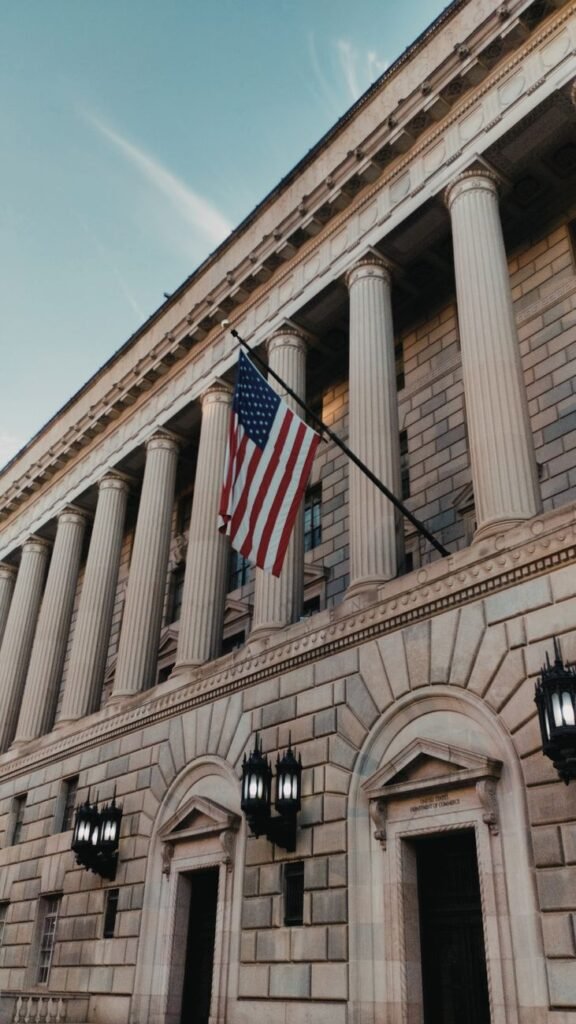 us flag on the facade of the department of commerce in washington dc united states of america