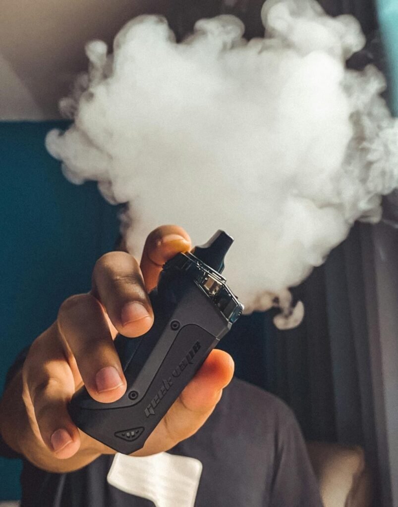 Person holding black vape - Photo by Renz Macoro Pexels
