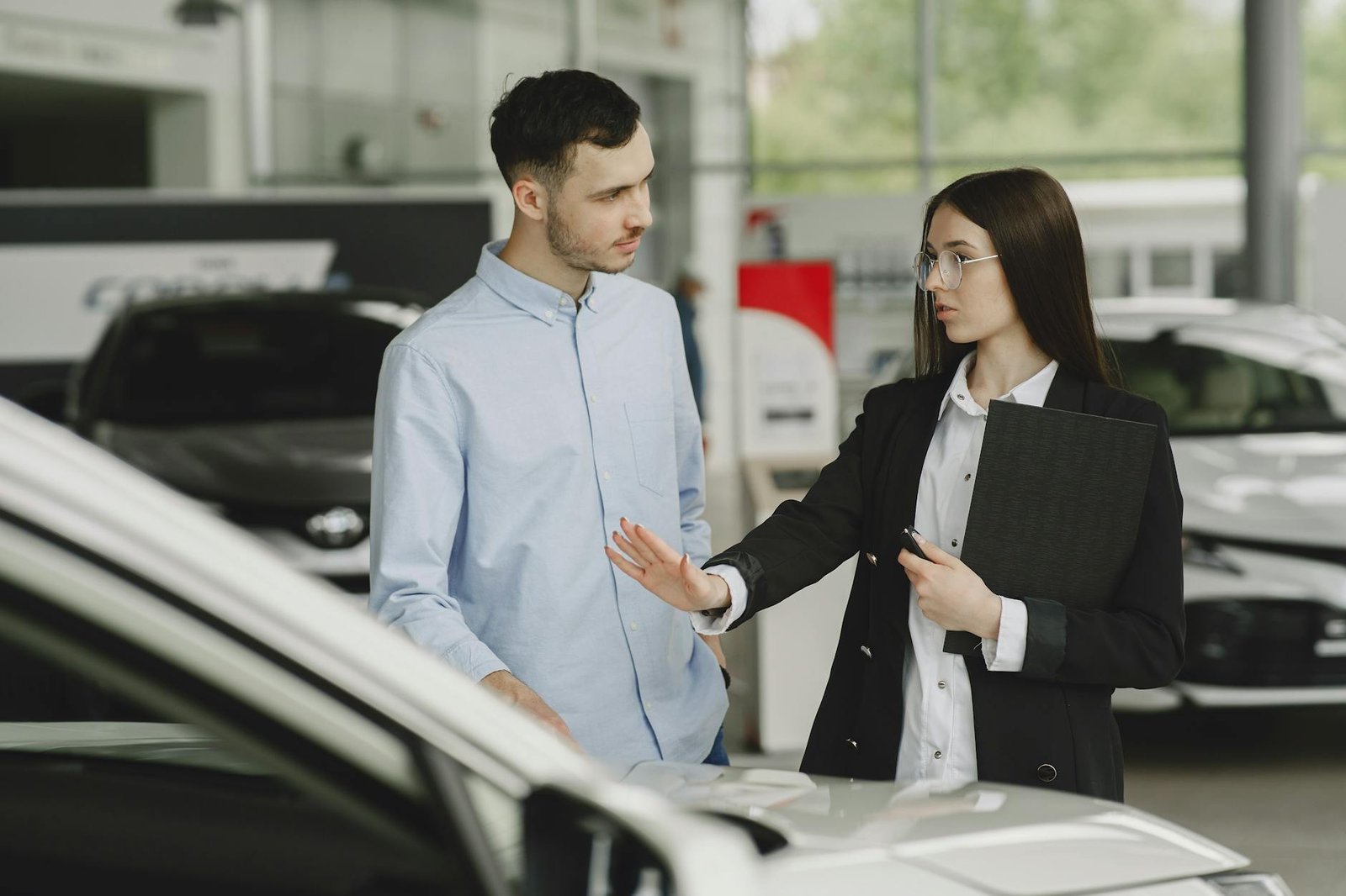 woman selling car to client in salon