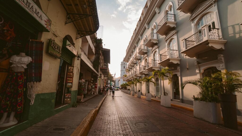 person walking on road beside apartment