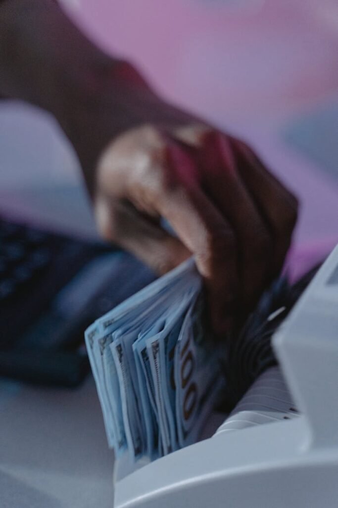 a person holding a sum of cash