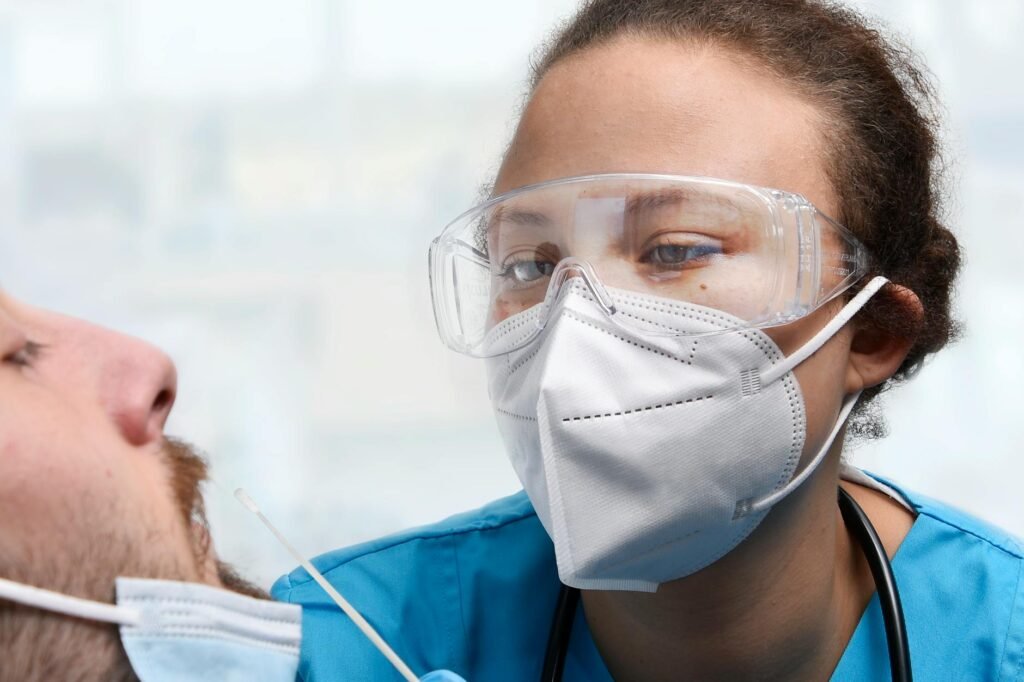 healthcare person doing a pcr test on bearded man