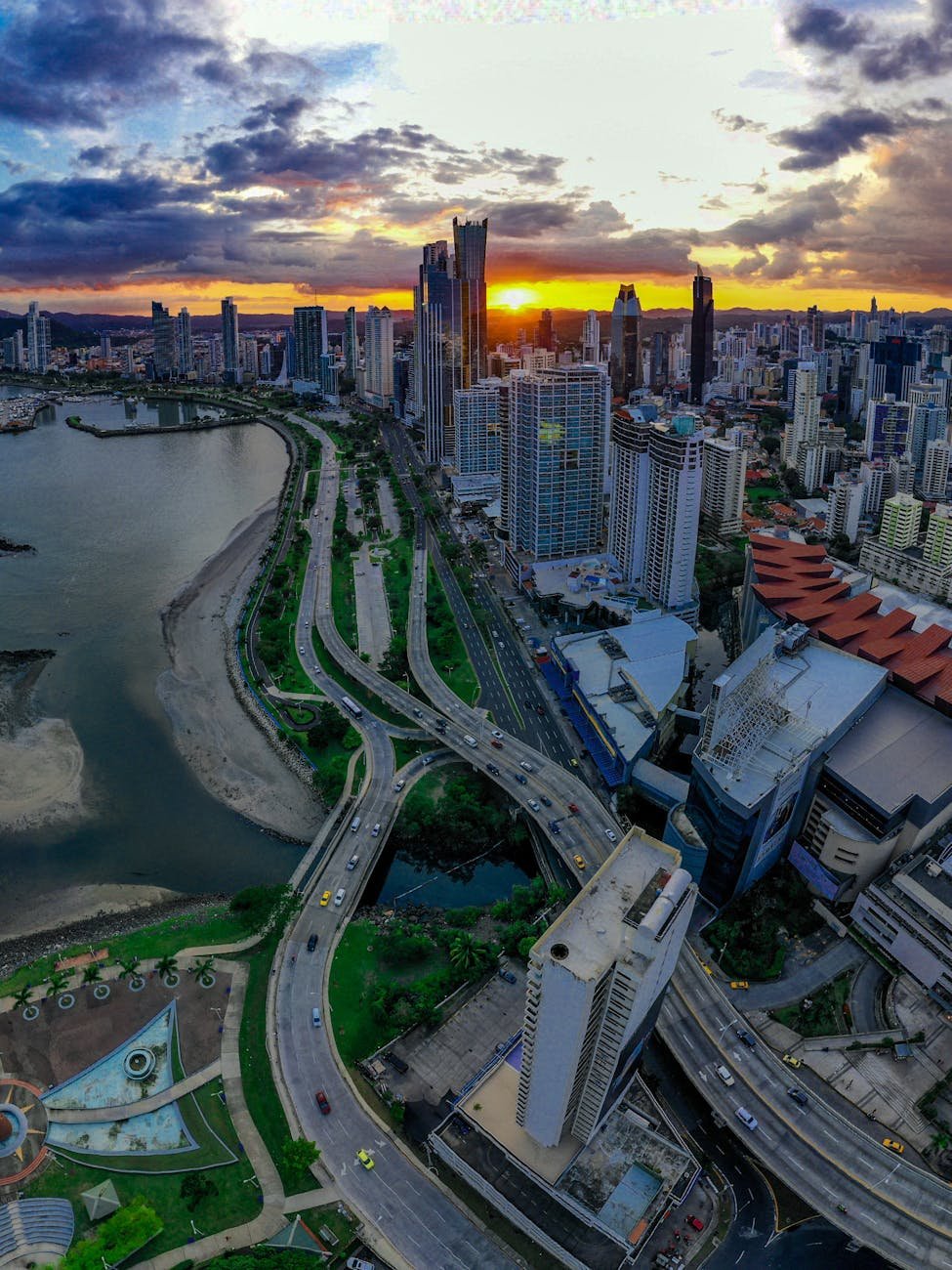 clouds over city on coast at sunset