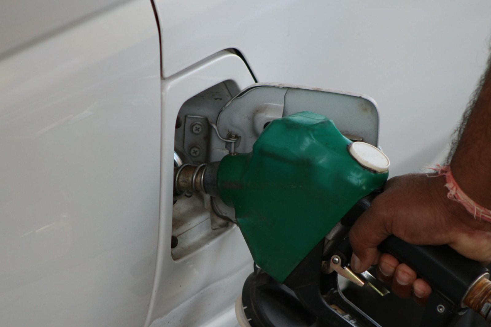 fuel pumping into car at a gas station