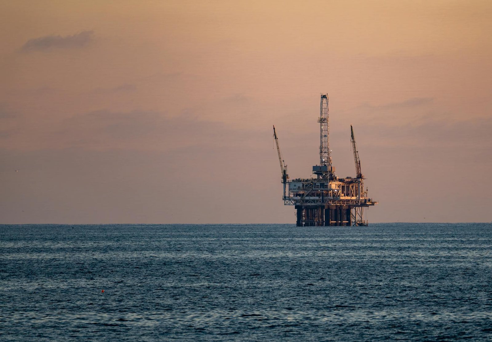 offshore oil rig at sunset in pacific ocean