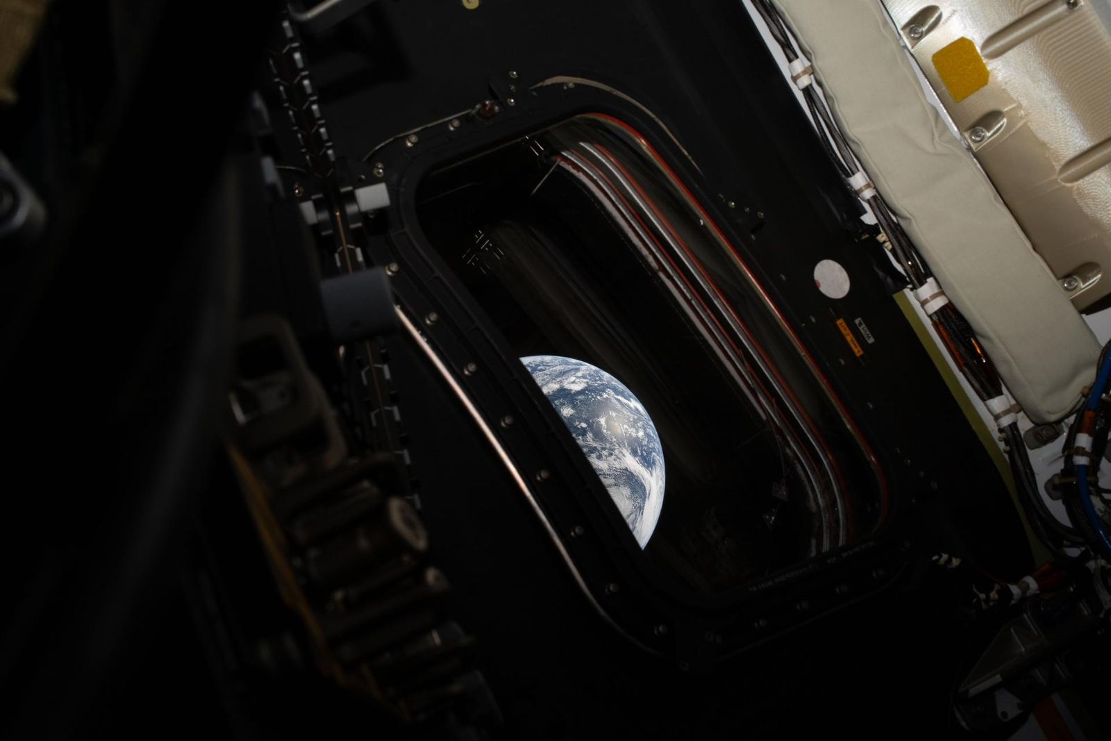 A view of Earth taken by NASA astronaut and Artemis II commander Reid Wiseman from one of the Orion spacecraft’s four main windows after completing the translunar injection burn on April 2, 2026. NASA